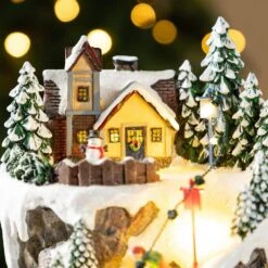 15.50 In. Lighted Skiing Moutain Resin Christmas Village With Movement And Music -Christmas Decor Shop glitzhome christmas villages 2040200001 44 1000